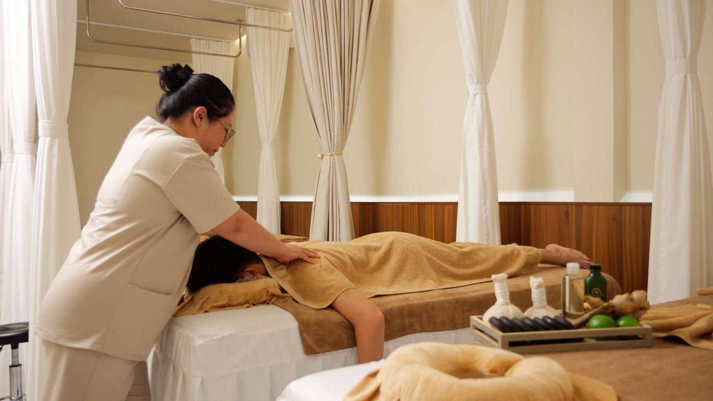Woman relaxing peacefully in a warm wellness space